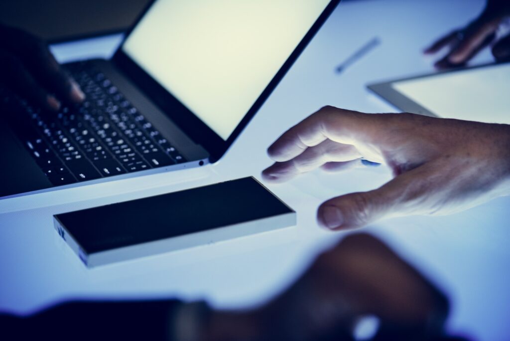 Hand on a laptop working at cyber space table